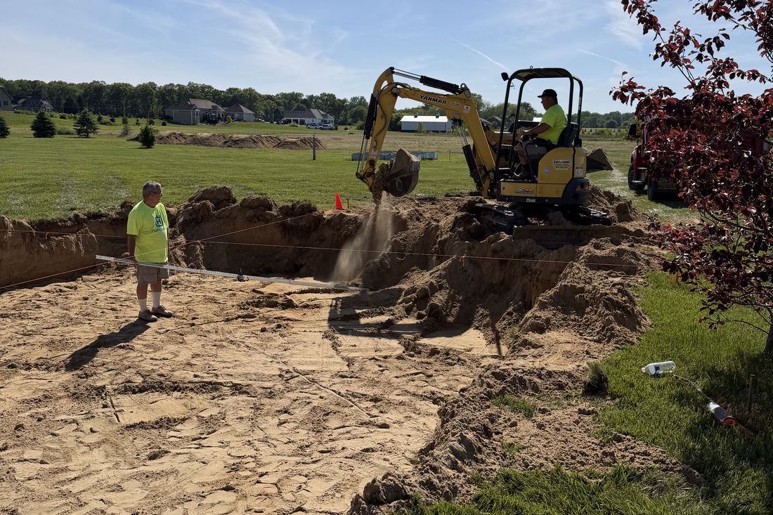 Brighton Pools crew excavating a backyard for a new in-ground pool